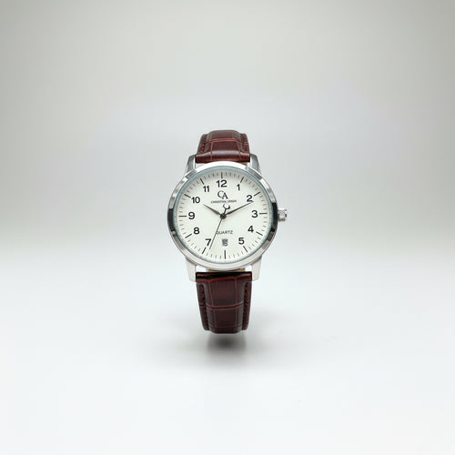 A wristwatch with a brown alligator-patterned leather strap and a silver-tone case, held in a person's hand against a gray textured background.