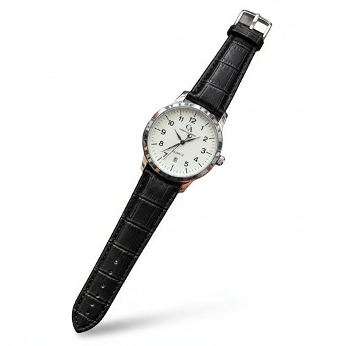A wristwatch with a silver-tone case, white dial, and black crocodile-embossed strap, held in a person's hand against a gray textured background.